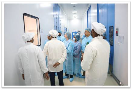 Delegation observing sterile formulation operations inside the facility